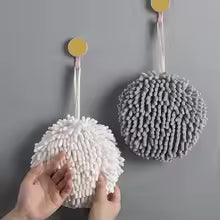 Gray and white fuzzy ball microfiber hand towel hanging on wall hooks with soft texture for cleaning