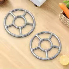 Set of two metal gas stove stabilizer bracket parts for cookware support on wooden surface