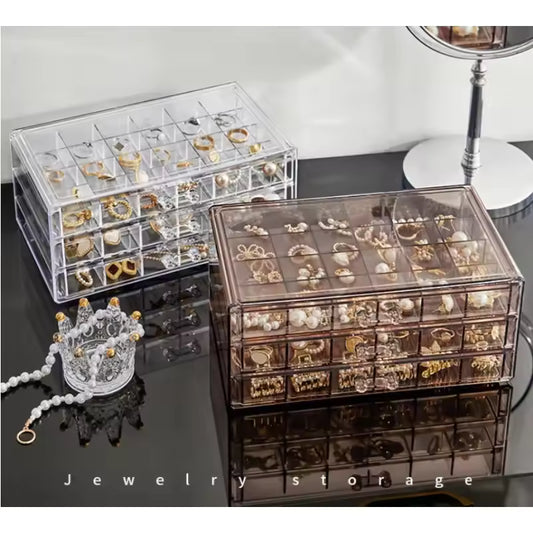 Clarify.pk acrylic drawer jewelry storage cases in clear and smoky finishes holding various rings and earrings