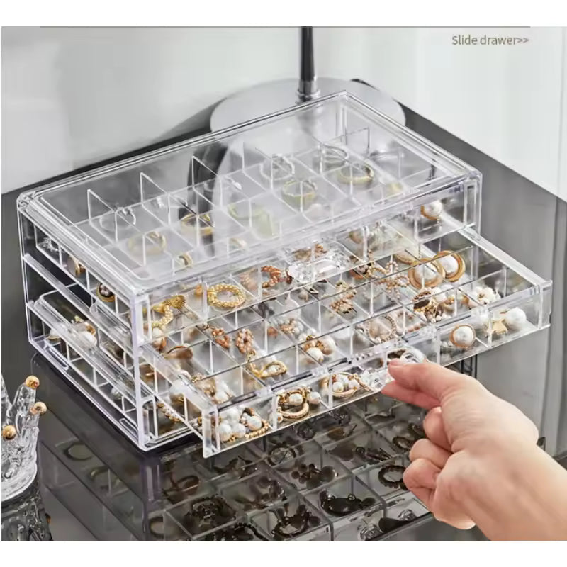 Clarify.pk acrylic drawer jewelry storage with multiple compartments holding rings and earrings