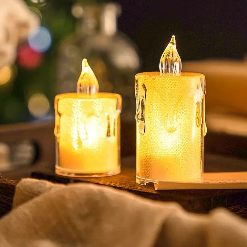 Two glowing acrylic LED candle lamps with realistic flame design on a wooden surface