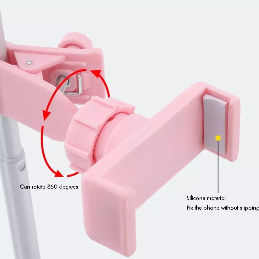 Close-up of pink foldable selfie stick with ring light phone holder showing 360-degree rotation and silicone grip