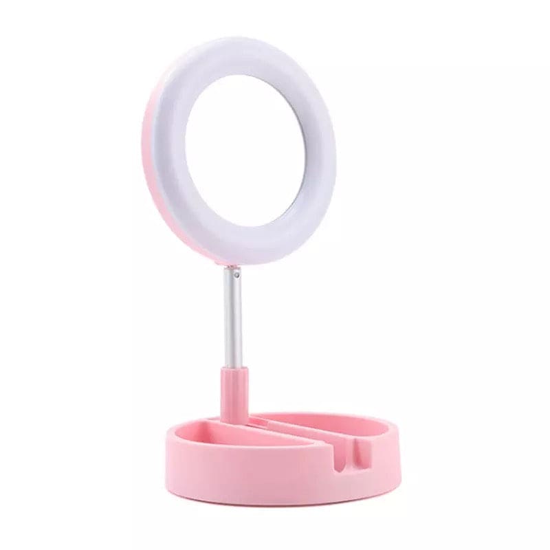 Pink foldable selfie stick with ring light on a white background for enhanced lighting