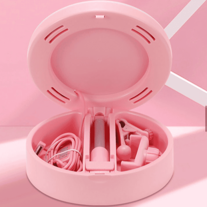 Pink foldable selfie stick with ring light neatly stored in round compact case with accessories