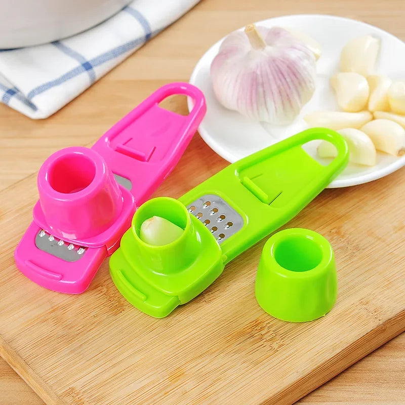 Clarify.pk colorful ginger garlic crusher tool set with green and pink handheld crushers on wooden board
