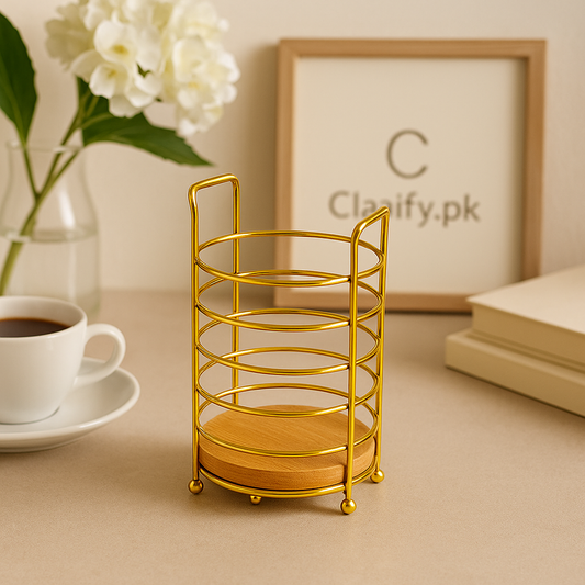 Elegant golden holder with wooden base displayed on beige table near coffee cup and flowers