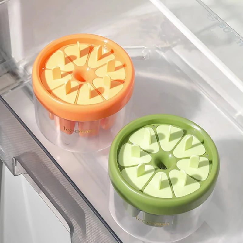 Clarify.pk ice cream maker with orange and green lids stored in refrigerator drawer