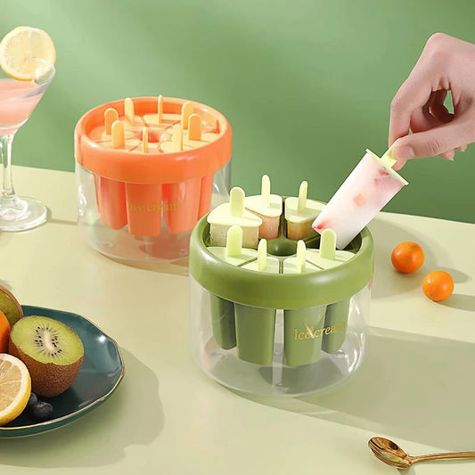 Clarify.pk ice cream maker set with green and orange molds for homemade popsicles on table