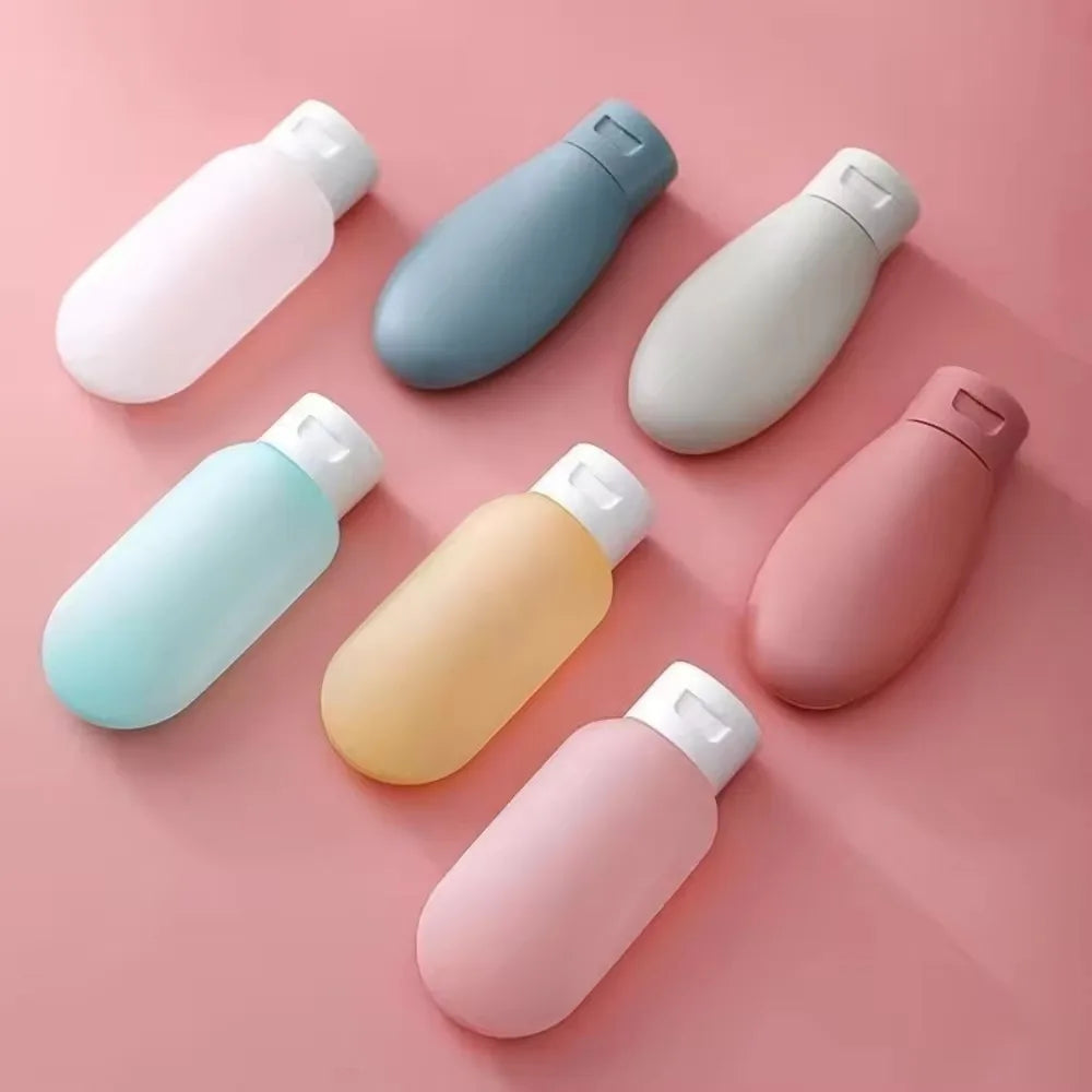 Clarify.pk portable lotion container 3 pack with multiple pastel refillable bottles on pink background