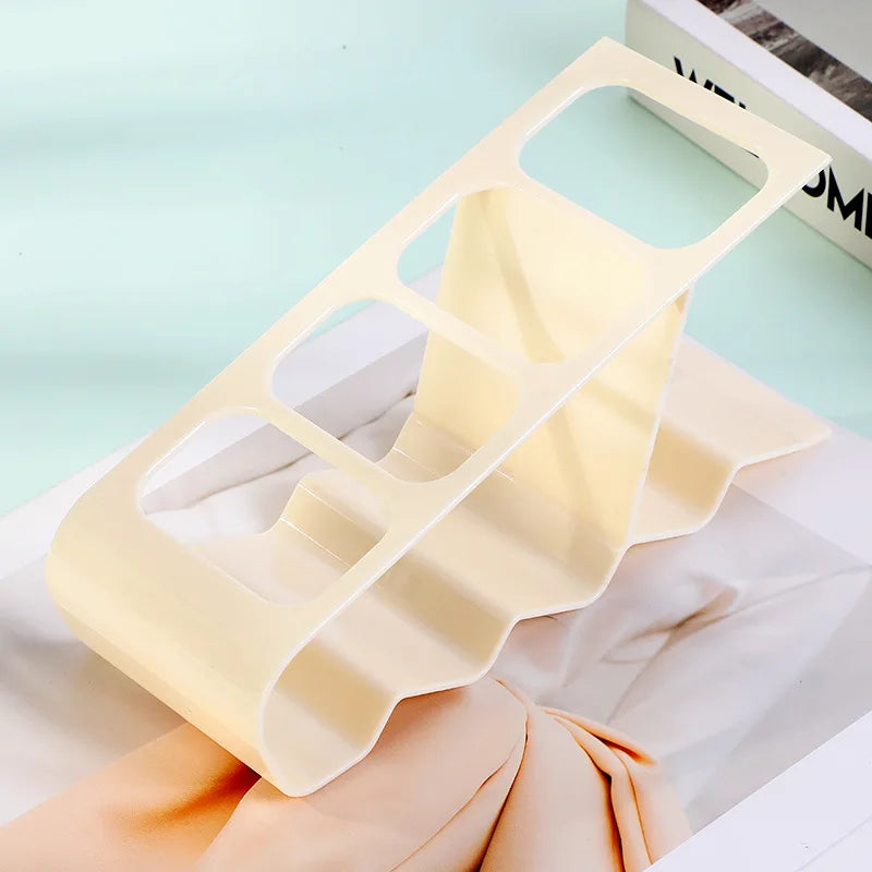 Cream-colored plastic TV remote stand holder with multiple slots for organizing remotes
