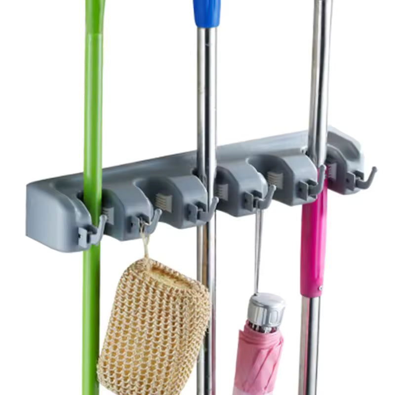 Wall mounted mop holder by Clarify.pk holding multiple cleaning tools and accessories