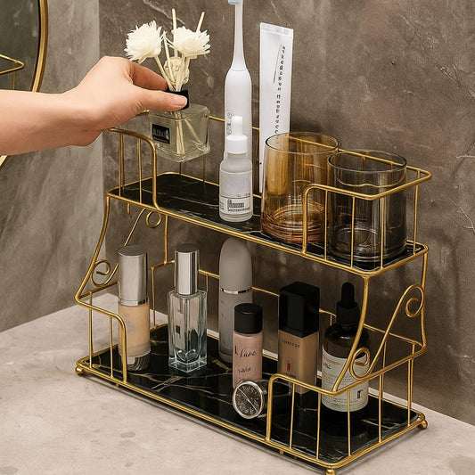 Elegant 2 layer cosmetic organizer with gold metal frame and black base holding various skincare and makeup products