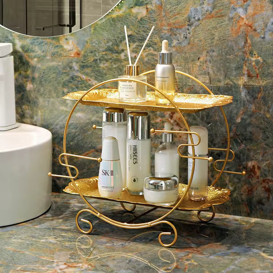 Clarify.pk elegant gold 2 tier bathroom organizer holding skincare bottles on marble countertop