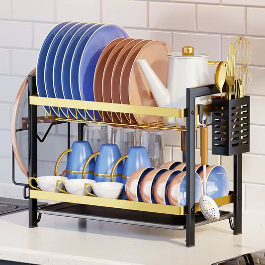 Clarify.pk dish drying rack holding plates, cups, utensils, and a teapot on kitchen counter