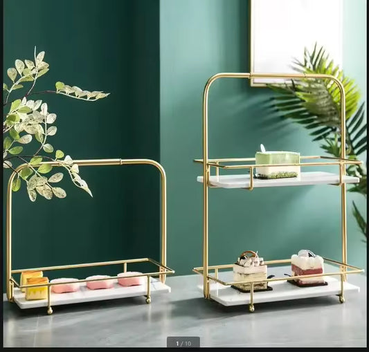 Elegant iron display stand for snacks with gold frame and white marble base holding assorted desserts