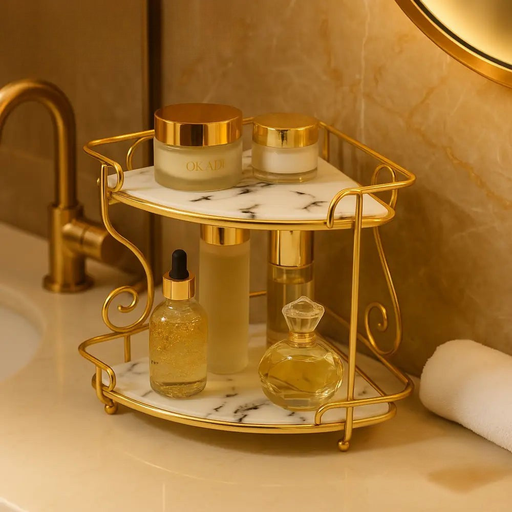 Luxury 2-tier organizer rack with gold frame and marble shelves holding skincare bottles on bathroom counter