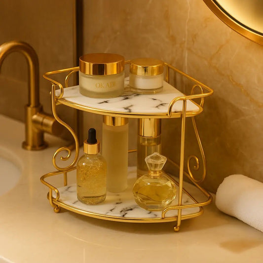 Luxury 2-tier organizer rack with gold frame and marble shelves holding skincare bottles on bathroom counter