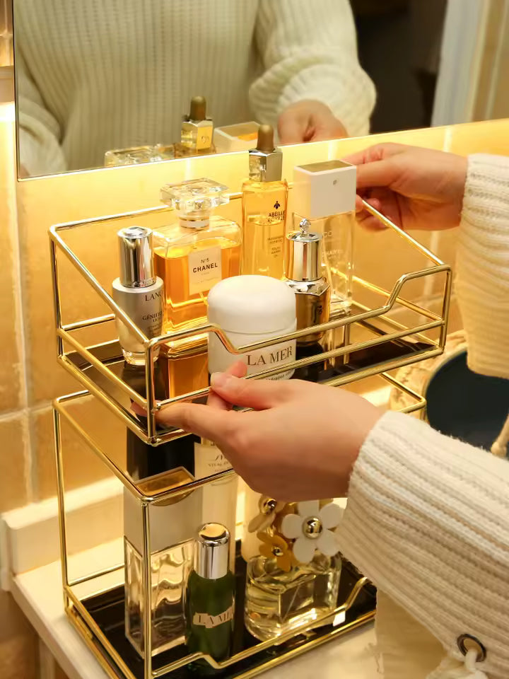 Clarify.pk gold desktop makeup organizer rack with multiple compartments holding perfume and skincare bottles