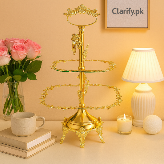 Elegant gold 2 tier dessert stand with ornate design displayed on a table with roses and soft lighting
