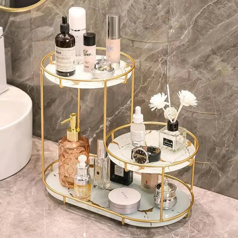 Clarify.pk cosmetics organizer bathroom furniture with gold frame and white marble trays holding skincare and fragrance bottles