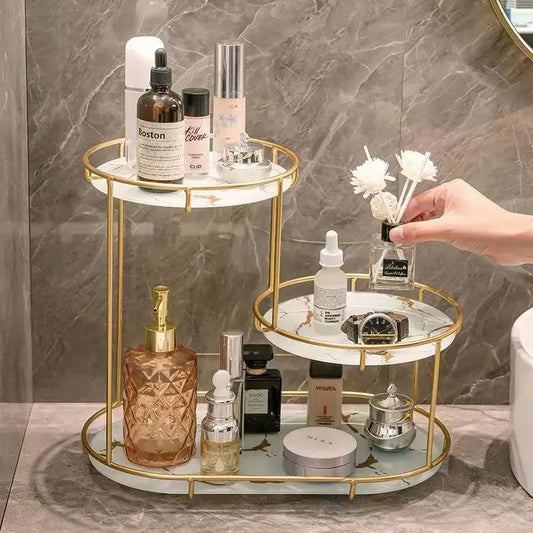 Elegant cosmetics organizer with gold frame and marble shelves holding skincare and beauty products