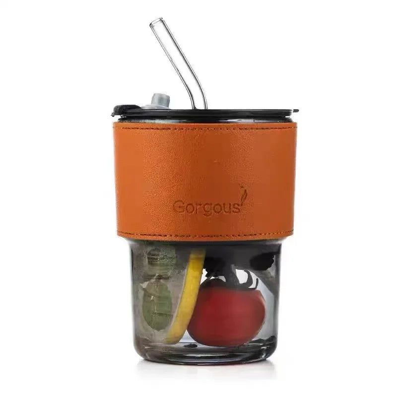 Clear bamboo node glass straw cup with brown leather sleeve and fresh fruit inside