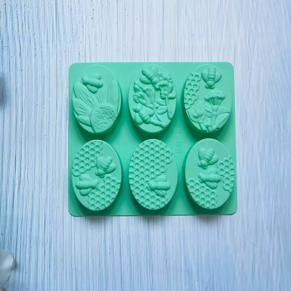 Clarify.pk 6 cavity oval soap mold with detailed floral and bee designs in green silicone