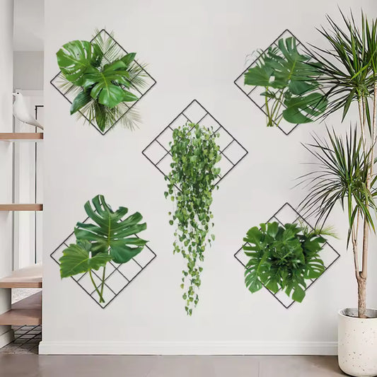 Green plant wall stickers arranged in diamond-shaped black frames on a white wall in modern living space