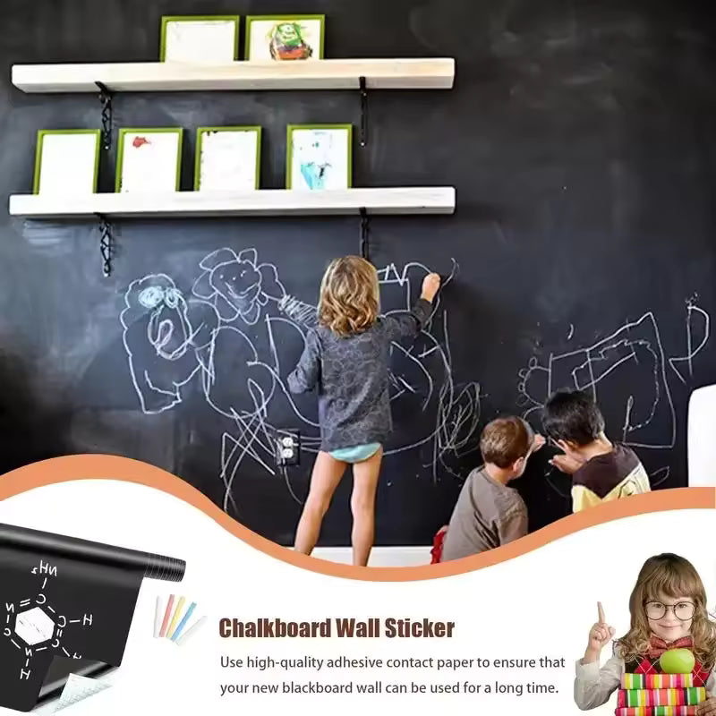 Children drawing on a large blackboard sticker for wall in a playroom with framed photos on shelves