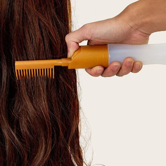 Clarify.pk hair dye applicator bottle with comb attachment applying color to long brown hair
