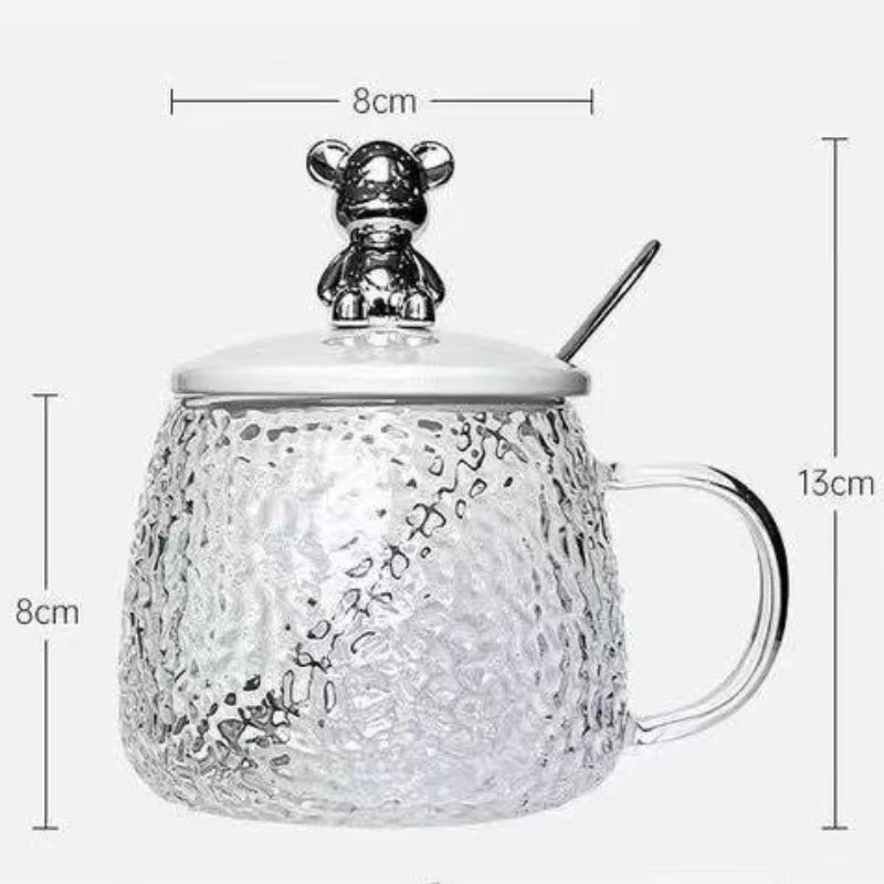 Hammered glass coffee cup with lid and decorative bear knob with spoon, 8cm wide and 13cm tall