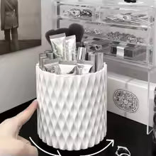 Clarify.pk brushes stored in a white round makeup organizer storage box with textured design