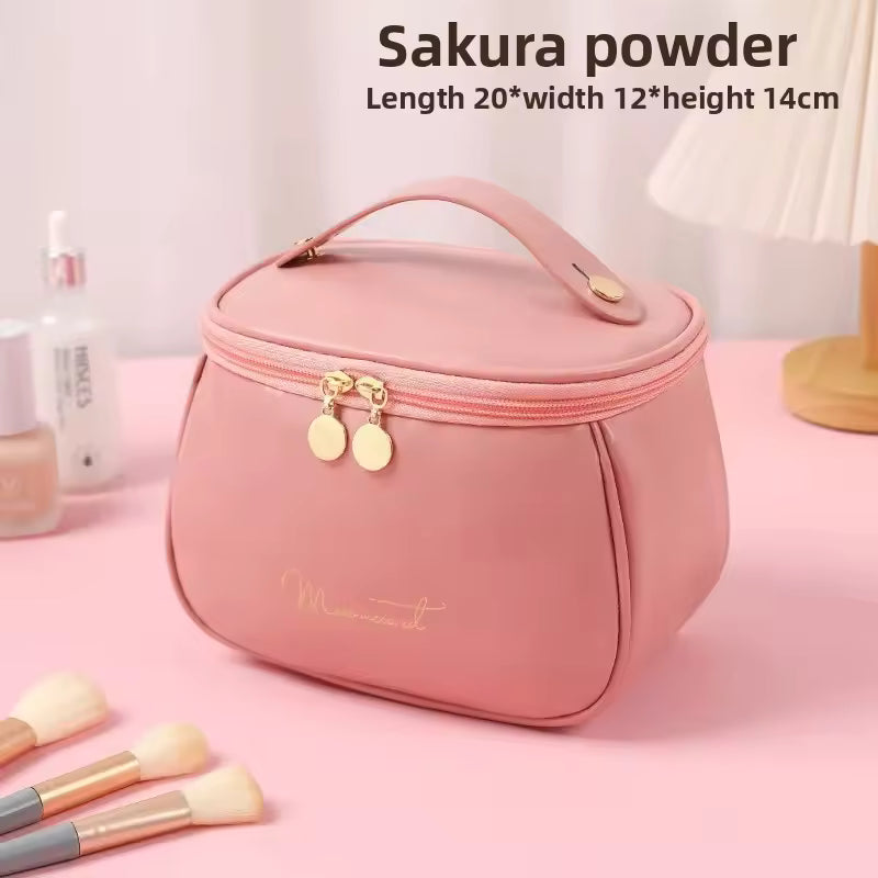 Clarify.pk handheld makeup wash bag in pink PU leather with gold zipper and top handle