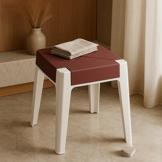 Clarify.pk heavy duty plastic stool with white legs and maroon seat placed indoors with folded cloth on top