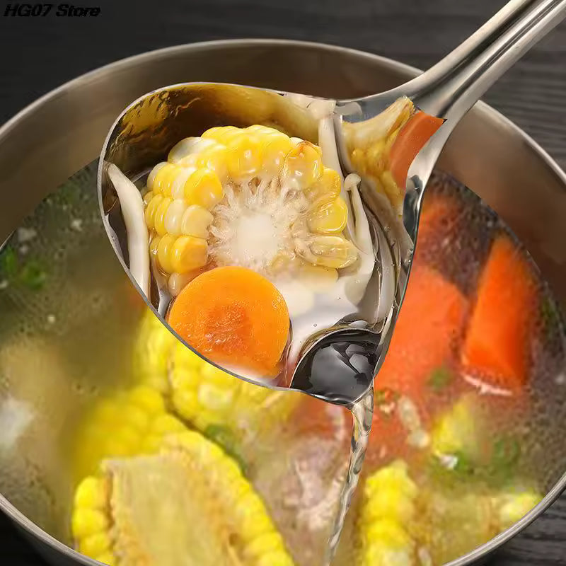 Stainless steel oil separator spoon lifting corn and carrot from boiling soup in pot