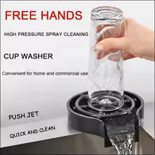 High pressure cup washer tool cleaning a glass bottle with water flow for home and commercial use