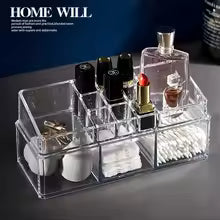 Clear trapezoid makeup stand for vanity with multiple compartments holding lipstick cotton swabs and other cosmetics