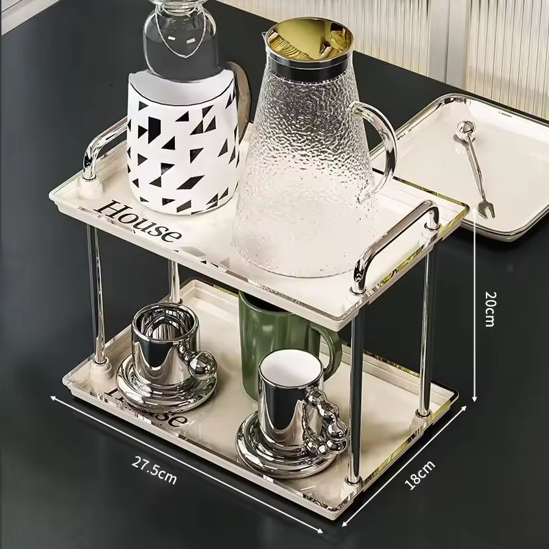 2 tier desktop cup rack organizer with glass pitcher and cups on a marble patterned stand