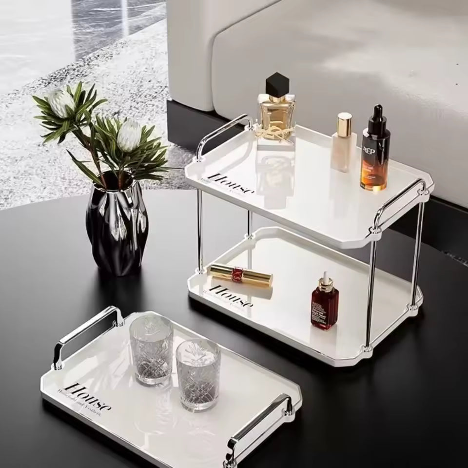 Clarify.pk 2 tier desktop cup rack organizer with white trays and chrome handles holding bottles and cosmetics