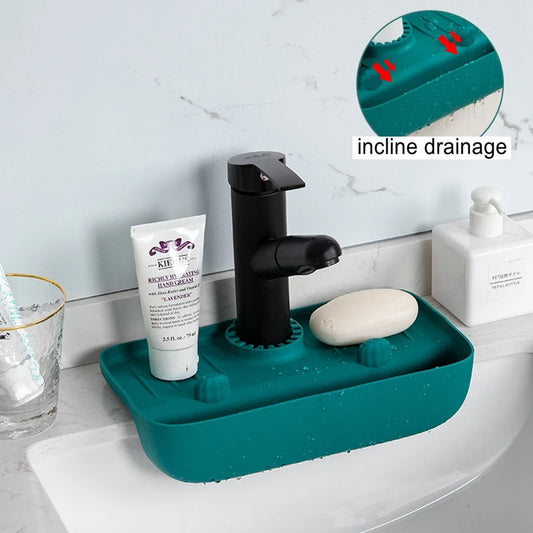 Clarify.pk silicone faucet mat in teal with incline drainage holding soap and lotion on bathroom sink