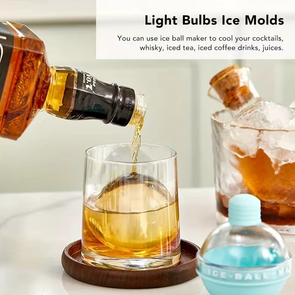 Clear whiskey glass with spherical ice molds being filled, showcasing light bulbs ice molds for cocktails