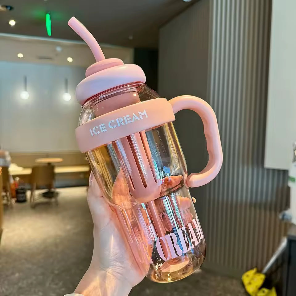 Large capacity plastic water bottle with pink handle straw and ice cream design held in hand