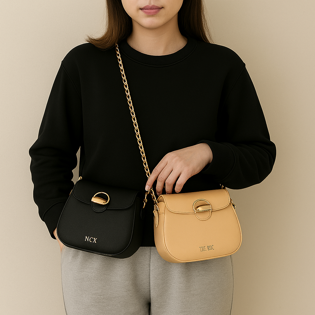 Black and beige portable straw cup with bag held by person wearing black sweater and gray pants