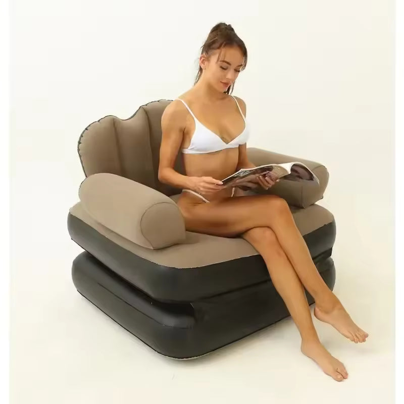Inflatable sofa bed in brown and black with comfortable backrest and armrests, modeled by a woman reading
