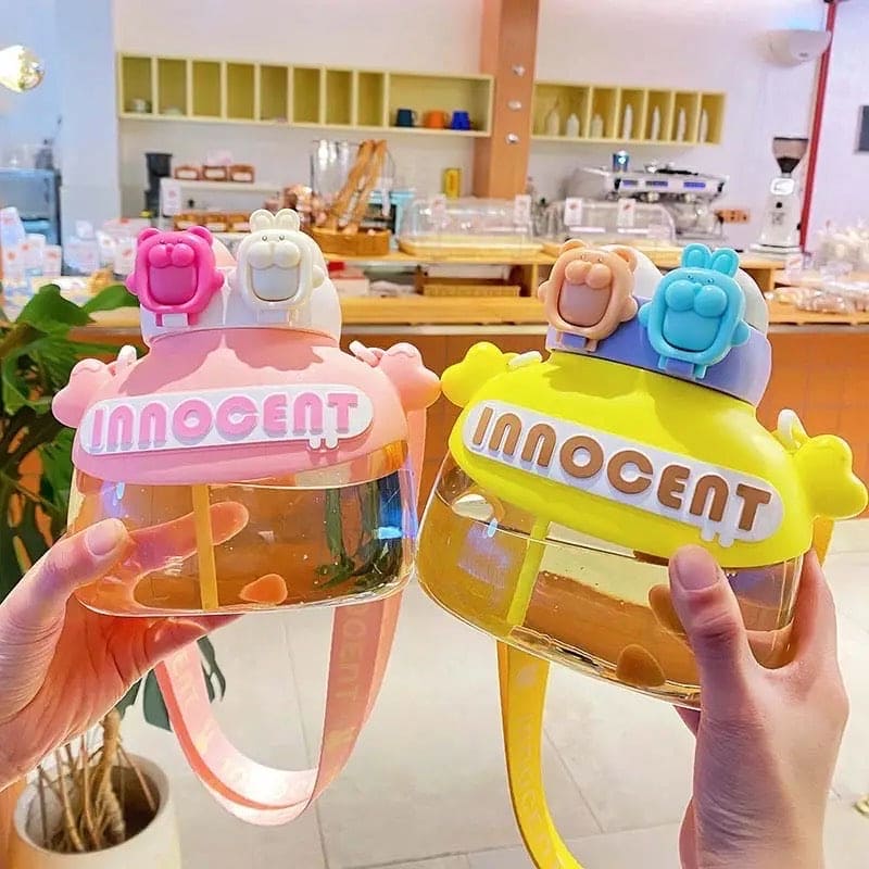 Fun student drink tumbler 1200ml in pink and yellow with playful bear-shaped lids and transparent body