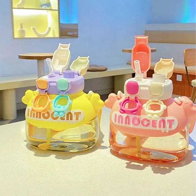 Colorful fun student drink tumbler 1200ml with cartoon design in yellow and pink colors on table