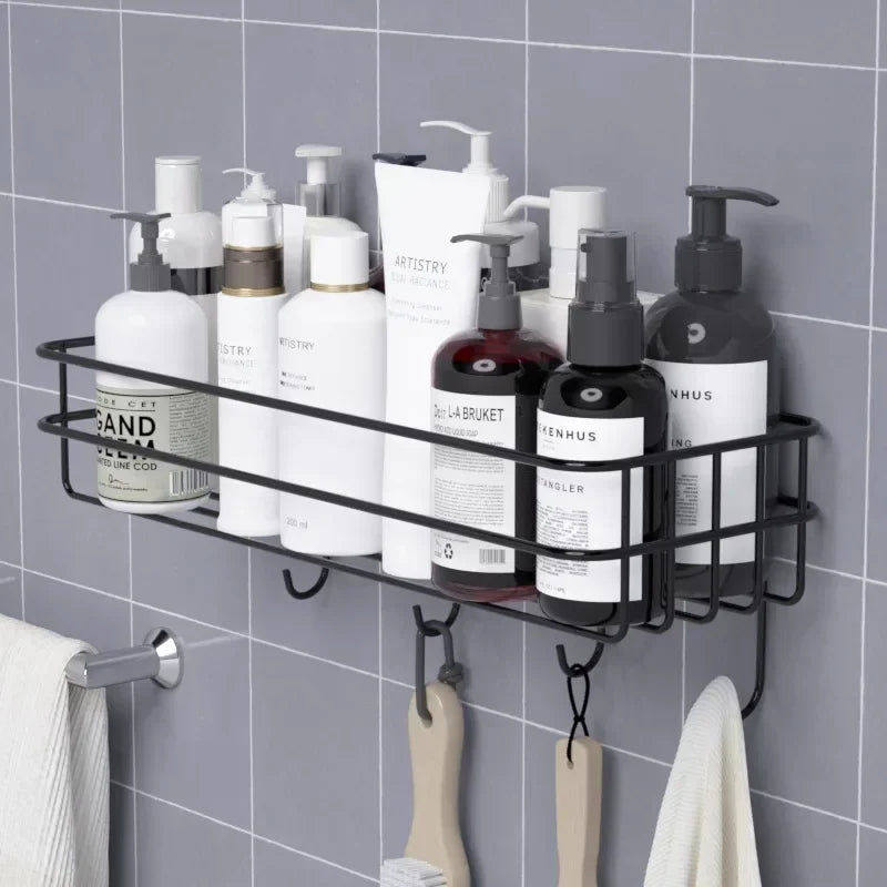 Black metal Japanese style bathroom rack mounted on tiled wall holding various bottles and hanging towels
