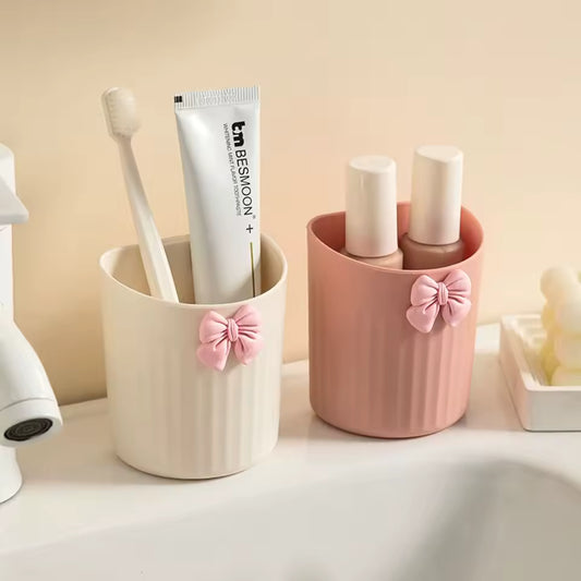 Kawaii pen holder for desk in cream and pink colors with decorative bows holding toiletries