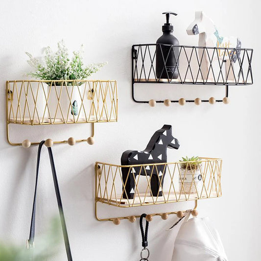 Key holder wall rack with hooks in black and gold metal wire design holding plants and decor items