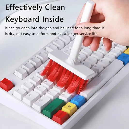 Keyboard cleaning brush kit with red bristles effectively cleaning between white keyboard keys